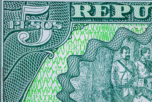 Close-up of a green Cuban 5 pesos banknote featuring . Detailed macro shot of Cuba currency paper money bill, 2019 series.