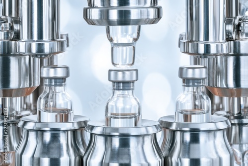 Automated production line filling glass vials with liquid medication