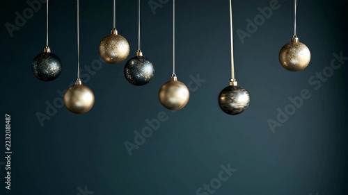 Christmas ornaments and snowflake decorations hang from strings against a dark blue background