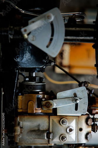 Vintage machine lever and gauge showing open control