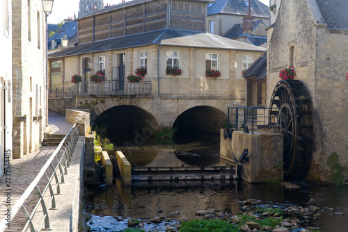 Idyllic scenery at French city of Bayeux with Aure River, water wheel and historic buildings on a sunny summer afternoon. Photo taken July 17th, 2026, Bayeux, Normandie, France.