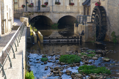 Idyllic scenery at French city of Bayeux with Aure River, water wheel and historic buildings on a sunny summer afternoon. Photo taken July 17th, 2026, Bayeux, Normandie, France.