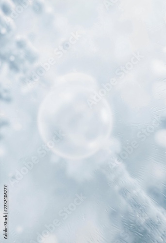 Soft blurry light blue abstract background with circular glowing bokeh and gentle frosted glass texture