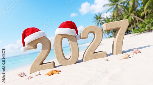 Sand numbers 2027 decorated with festive red hats on a sunny tropical beach