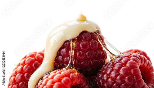 Close-up eye-level view of white chocolate melted smoothly over fresh red raspberries, glossy dripping textures, isolated on white background.