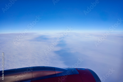 airplane flying in the sky, plane engine sky ,fuselage, view from passenger window, blue sky clouds .