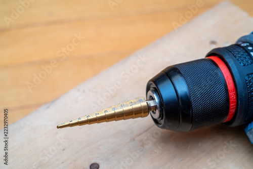 Fotografie Golden drill bit attached to power tool