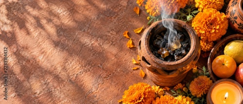 Incense burning in a terracotta holder beside marigolds and a candle. Day of the Dead altar offering. Mexican cultural tradition and remembrance. Autumn festival with copy. Banner format