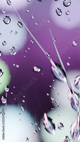 Vertical video: Sliding water droplets elongating and merging on upright glass pane