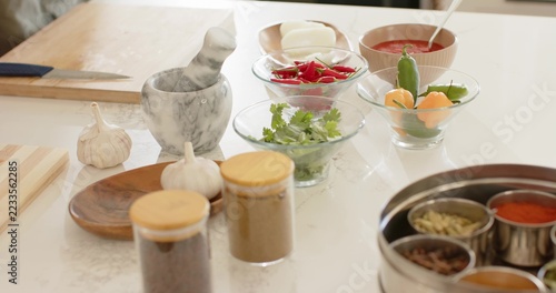 Prep ingredients sitting on countertop, mortar pestle, bowls of chilies, sauce spoon
