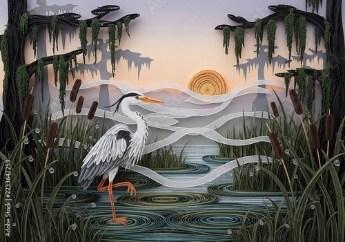 Quilling paper art of heron standing in swamp among cattails and cypress trees at sunset