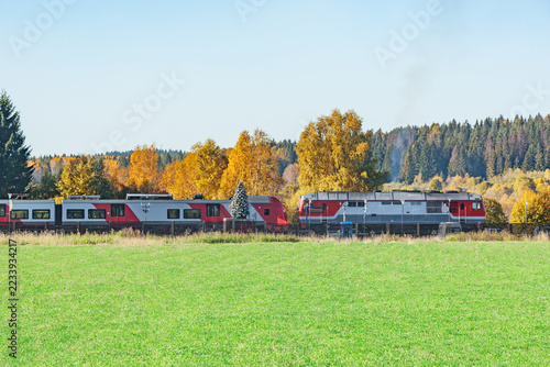 Passenger train stands by the platform.
