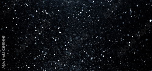 Snowfall with frosty particles on black. Snow overlay layer with flying snow. Realistic snowstorm winter motion. Snowflakes forming cold background. Snow texture overlay with drifting particles.