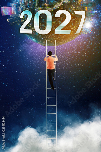 Businessman Climbing Ladder to 2027 World Globe in Space Concept
