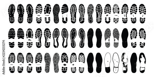 Set of various black shoe tread patterns and footprints isolated on a flat surface