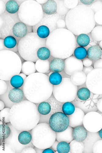Blue white Christmas glittering tree decorations with sphere shape balls background. Festive symbols for the holiday season greeting card.