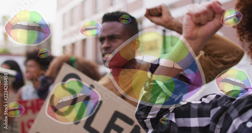 Image of rainbow lips over diverse protesters with banners
