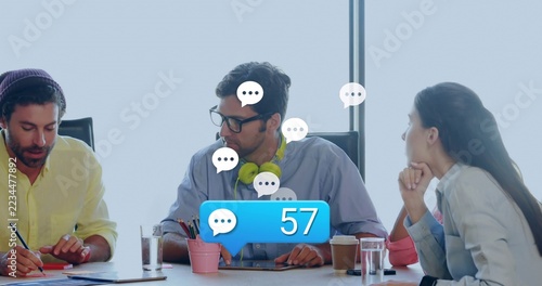 Reviewing man wearing glasses with green headphones reading papers in meeting room, blue badge 57