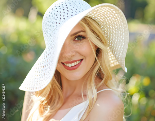 High-Key Summer Portrait of Woman in Straw Hat with Lace Shadows.