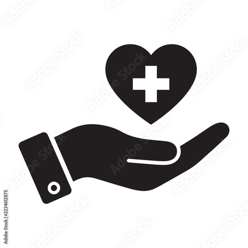 Hand holding a heart with a medical cross symbol