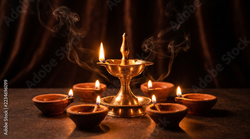 Glowing Brass Oil Lamp Surrounded by Diyas During Diwali
