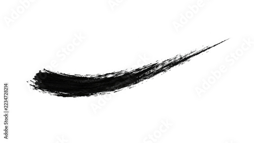 Single black ink brush stroke isolated on a white background for artistic design and graphic element projects
