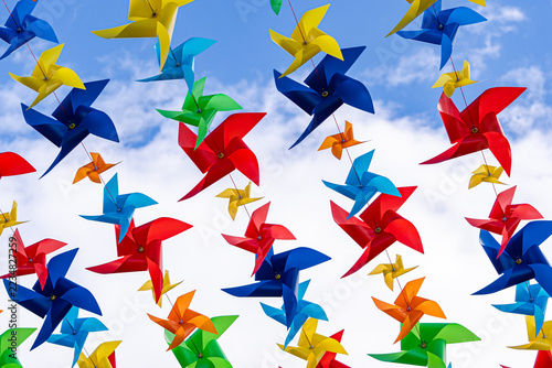 Colorful pinwheel decoration against blue sky at festival