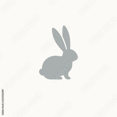 Grey minimalist rabbit silhouette icon sitting animal symbol isolated on clean background