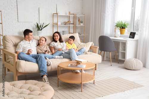 Fotografie Family bonding and quality time, parents and children relaxing on a sofa in a br