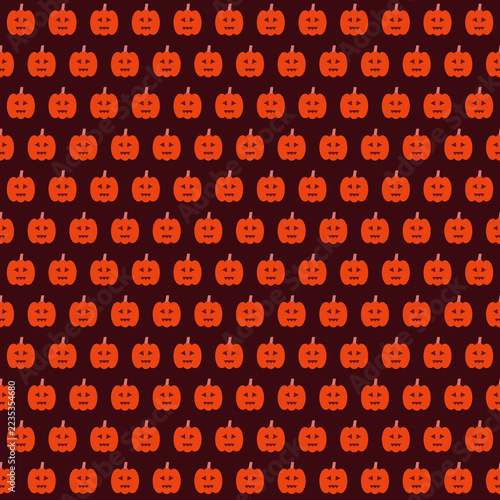 Seamless pattern with cute orange pumpkins on a dark background for Halloween design