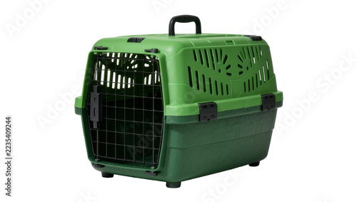 Green plastic pet carrier with black metal door and handle, isolated on transparent background