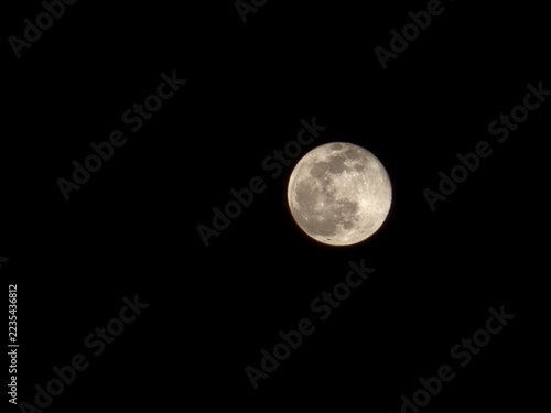Fotografie full moon over black