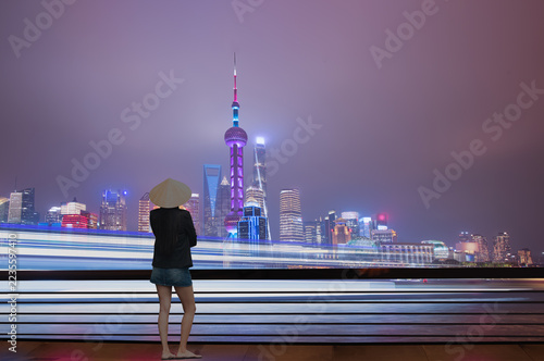 Photography Shanghai colorful skyline with motion speed light of passing ferry in the foregr