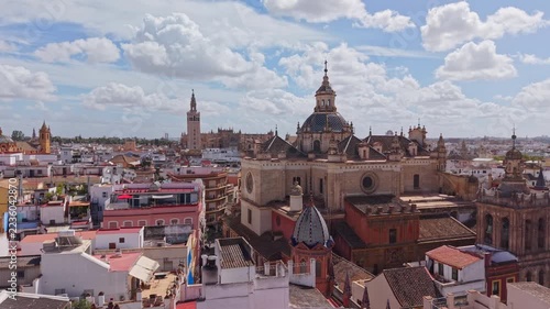 Aerial view of a church dome and the packed streets of the Seville old quarter, Spain.