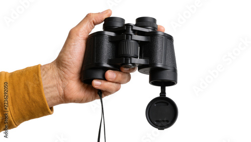 Fotografie Hand holding black binoculars with lens cap and adjustable focus wheel