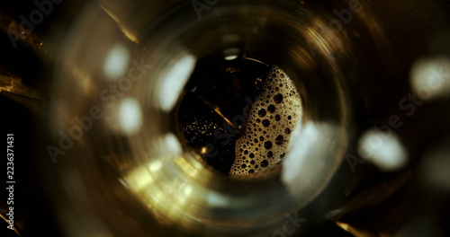 Close-up of beer poured in glass against black background