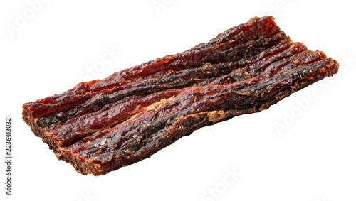 Obraz na plátně Dark brown seasoned beef jerky strip with textured surface