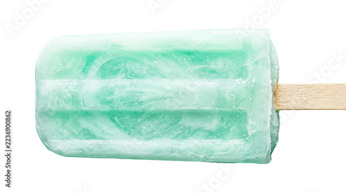 Fotografie Refreshing mint flavored popsicle with icy texture on a wooden stick, a cool summer treat