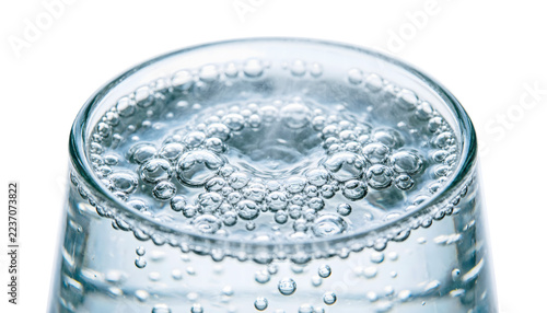 Top-down extreme carbonated sparkling water, hundreds of fizzing micro-bubbles bursting at the surface, on a white background.