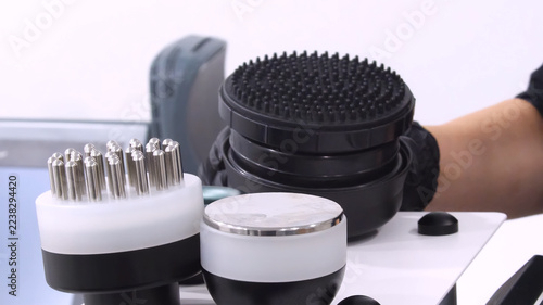 Professional body shaping therapy with vibromassage thermo vacuum and bioelectrical stimulation in beauty salon. 